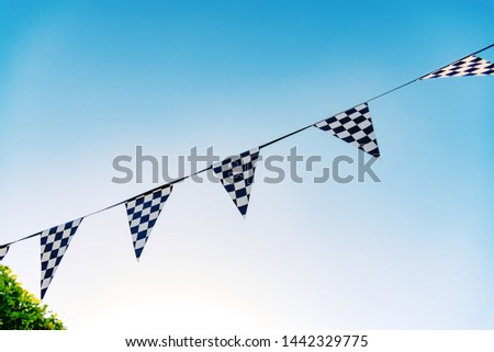 Decoration pennants with black and white squares like the flag of a car racing commissar.