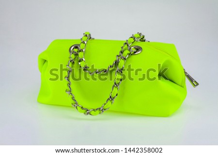 Neon green women's handbag With a hand strap in a silver chain