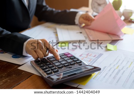 Bookkeeper or financial inspector hands making report, calculating. Home finances, investment, economy, saving money or insurance concept Royalty-Free Stock Photo #1442404049