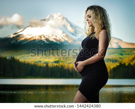 Pregnant woman . Nature background.