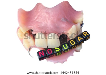 No sugar text from tiled letter blocks and sugar in a denture suggesting dieting concept isolated white background