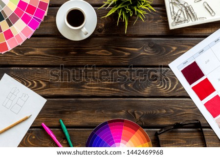 Work space of designer with instruments, pallet, pencils, glasses and coffee wooden background top view space for text