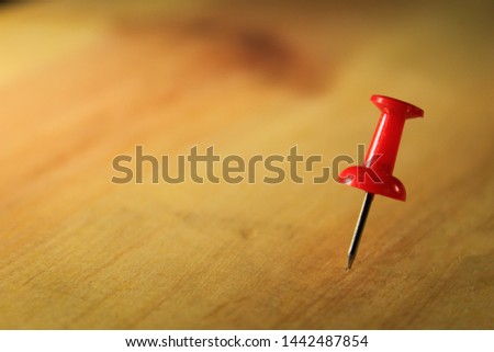 Set of push pins in different colors thumbtacks isolated on wooden background. copy space for text