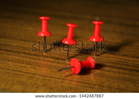 Set of push pins in different colors thumbtacks isolated on wooden background. copy space for text