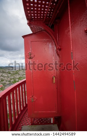 Open cast iron front door of the red top of the Lindesnes Lighthouse (Lindesnes fyr). Coastal beacon at the southernmost tip of Norway. It supports marine navigation in the entrance of Skagerrak.
