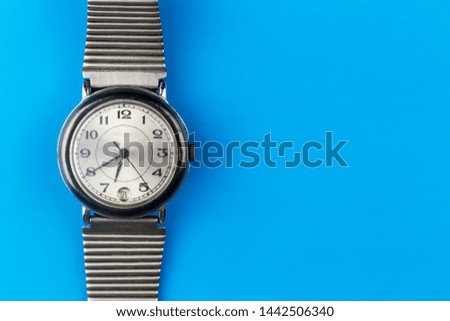 old mechanical wristwatch on a blue background
