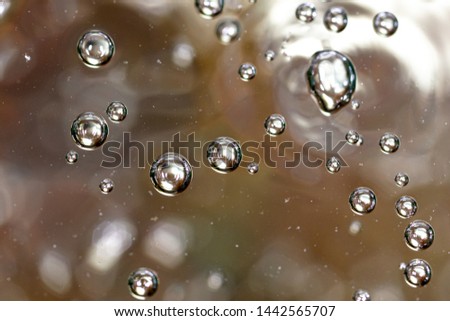 Bubbles of air on the surface of water as an abstract background .