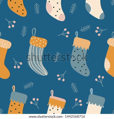 Christmas stockings and leaves seamless pattern. Vector design for wrapping paper, textile. 
