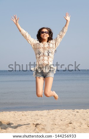 Beautiful girl jumping with joy