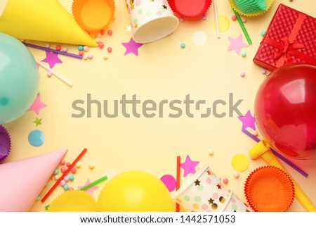 Frame made of Birthday decor on color background