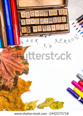 alphabet in wooden box, colorful pencils and markers, dry autumn leaves isolated on white background, Hello school, 1st September concept