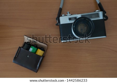 Old Vintage Film Camera and Leather Bag of Camera Films Preparing for Travel 