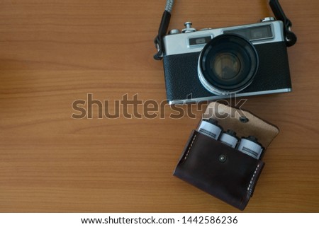 Old Vintage Film Camera and Leather Bag of Camera Films Preparing for Travel 