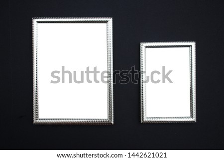 Two silver frames 10x15 and 15x20 with a white field on a dark background