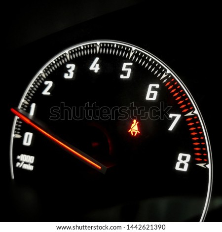 Close up of Car speedometer dashboard with Car Seat Belt red icon, Speed metre panel with red light meter in modern panel car