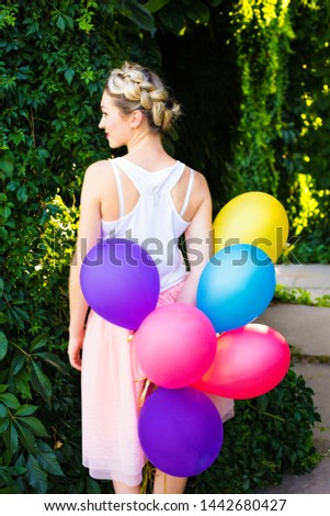 young girl celebrates the event with balloons