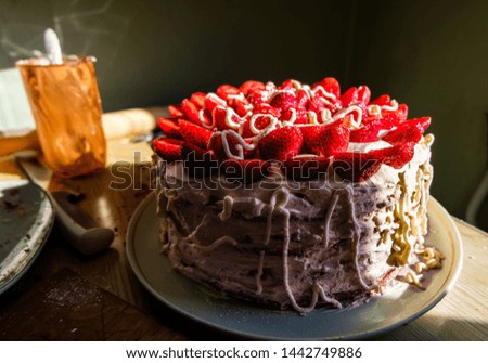 Handmade beautiful yummy cake with strawberries and whipped cream