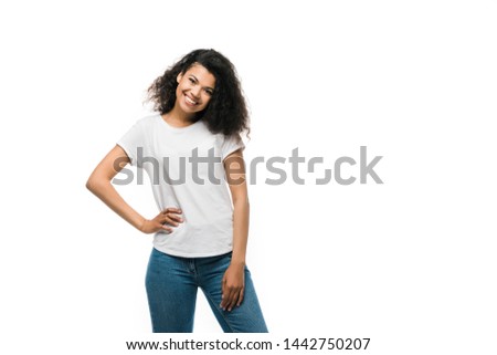 happy african american girl in white t-shirt standing with hand on hip isolated on white 