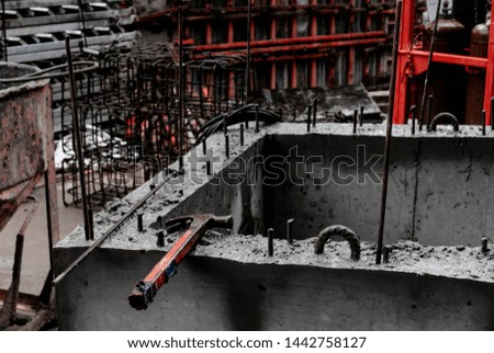 a view of a hammer on a concrete boarder full with rebar. photo in typical Bangkok construction site . Image by Shane Pasuthip