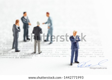 Group of businessmen in a suit and tie stipulate a signed contract. Signature on the contract