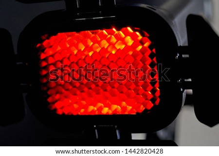 Spotlight with red light and honeycomb. Photo and video equipment for the Studio.