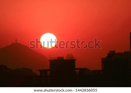 skyline of Hong Kong city with sun under sunset