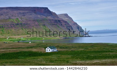 A view of the huge fjord and in the center of the picture is an isolated house in the nature reserve