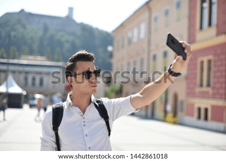 Student / tourist taking self portrait in the European city
