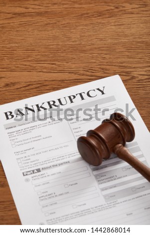 bankruptcy form under wooden gavel on brown wooden table