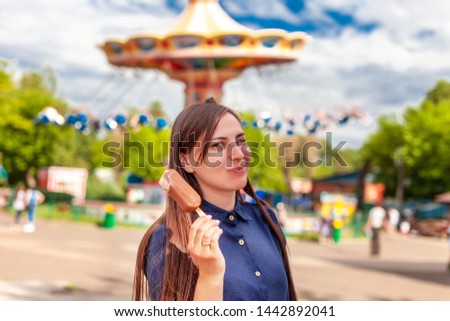 Woman with ice cream in the amusement park
