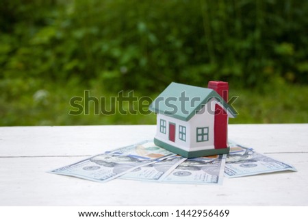 The house is worth a hundred dollar bills. Conceptual photo. Real estate, investment, mortgage