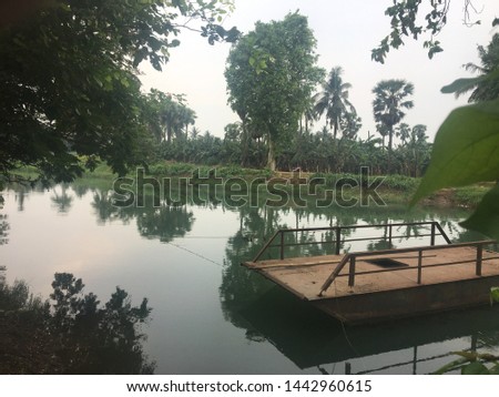 Old Car carrying boat in a pond hanging with green trees, Old Car carrier in landscape in amazing nature.   