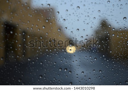 Water droplets on glass background, townhouses in the background