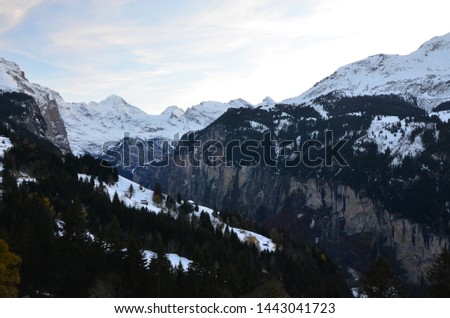 Switzerland village in early winter with snow mountain and autumn leaves