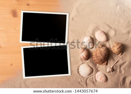 Empty photo cards lying on a sea sand. Sunny summer background. 