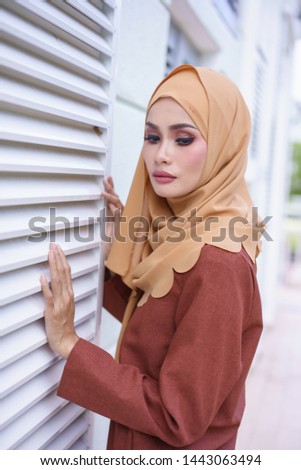 Beautiful young model in fashionable hijab style posing in urban environments. Stylish Muslim female hijab fashion lifestyle portraiture concept