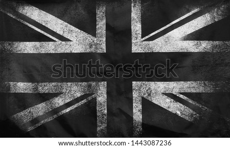 a monochrome full frame image of an old stained dirty union jack british flag with dark crumpled edges Royalty-Free Stock Photo #1443087236