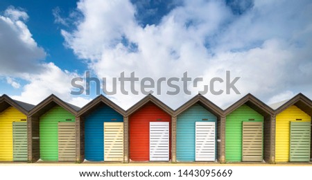 Colourful line of British beach huts at Blythe, Northumberland near Newcastle on the Northumbria Coast. Seafront coastline picture postcard landscape and holiday tourism destination.