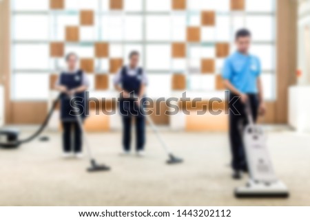 Cleaning office with vacuum. Picture blurred for background abstract and can be illustration to article of sanitary and health and cleaning business Royalty-Free Stock Photo #1443202112