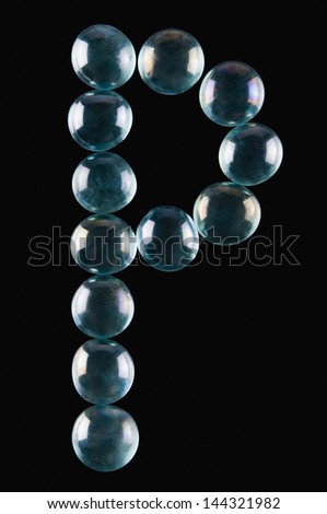 Close-up of marble balls arranged in the shape of letter P
