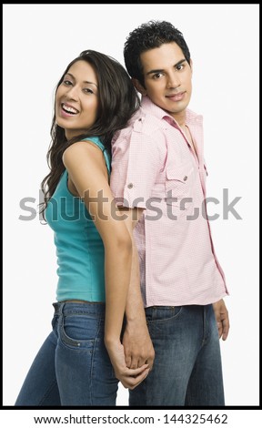 Couple standing back to back with holding hands