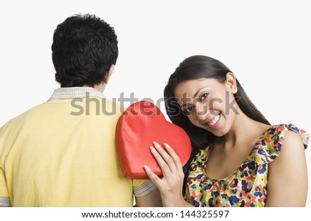 Woman leaning on a man's shoulder and holding a present