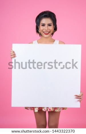 Portrait of fashion woman displaying white banner