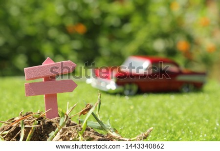 Rustic Signboard in Rural  Outdoor Area, Blurred car in background
