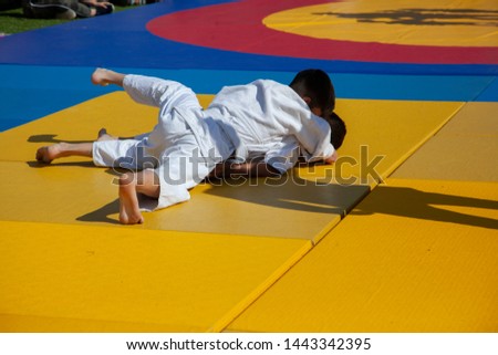 Children compete in the fight. Sports contests. Fights for karate. Children's section on martial arts. Sport for the family. Active lifestyle child