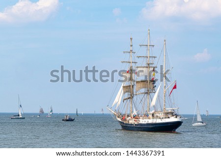 Troupe of antique tall ships, vessels leaving the harbor of The Hague, Scheveningen under a sunny and blue sky