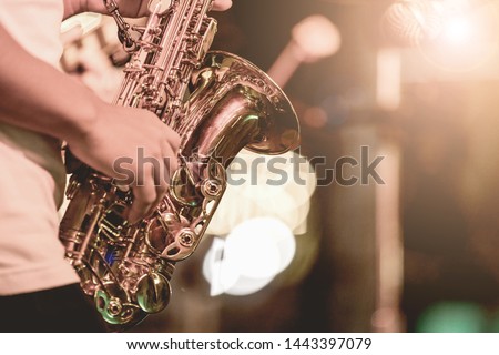  
,Saxophone Player hands Saxophonist playing jazz music. Alto sax musical instrument closeup Royalty-Free Stock Photo #1443397079