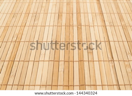 Bamboo brown straw mat as a background composition with a shallow depth of field