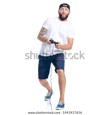 Man in shorts and cap with gamepad in hand on white background isolation