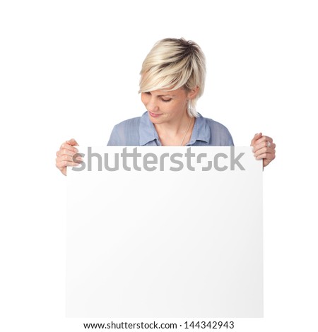 Young blond woman looking at white sign against white background